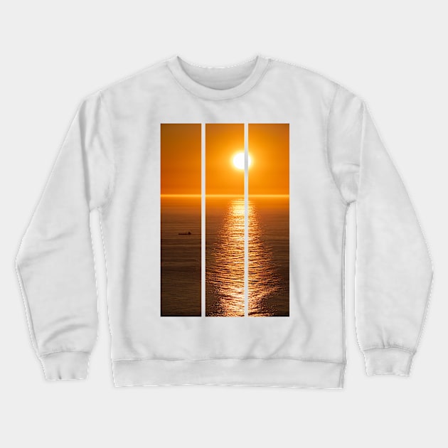 Wonderful landscapes in Norway. Nord-Norge. Beautiful scenery of a midnight sun sunset at Nordkapp (Cape North). Boat and globe on a cliff. Rippled sea and clear orange sky. (vertical) Crewneck Sweatshirt by fabbroni-art